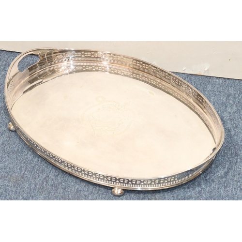 441 - A silver plated oval 2-handled tray with pierced gallery with engraved centre on bun feet, 56.5cm wi... 