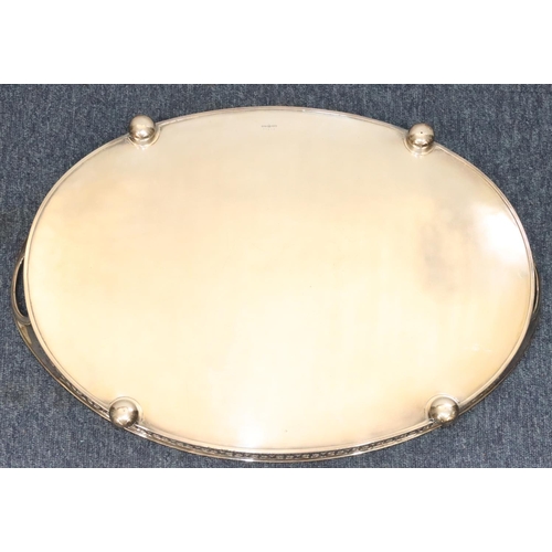 441 - A silver plated oval 2-handled tray with pierced gallery with engraved centre on bun feet, 56.5cm wi... 