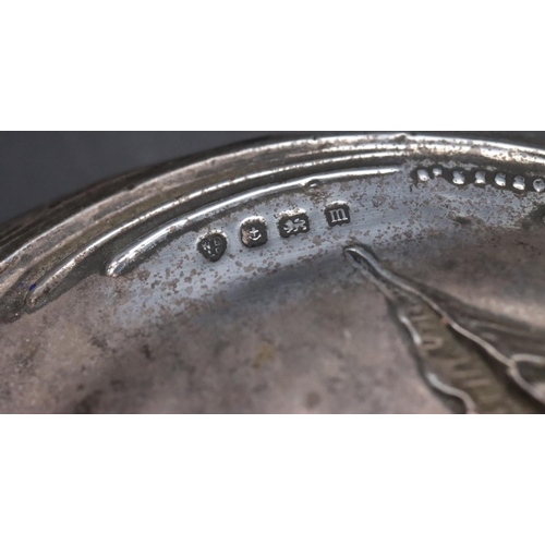 447 - A Birmingham silver hand mirror with embossed floral, leaf and scroll decoration and a matching brus... 