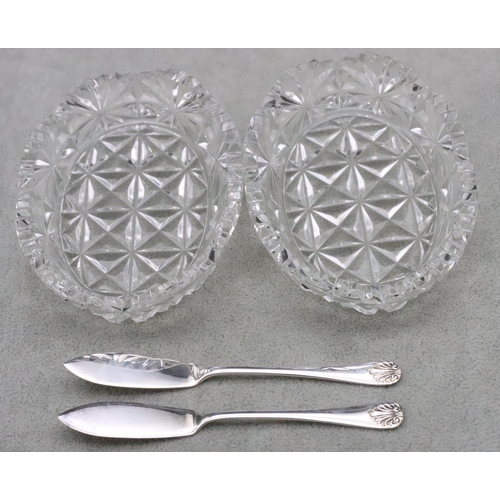 452 - A pair of cut glass oval butter dishes with a pair of Birmingham silver butter knives in fitted blac... 