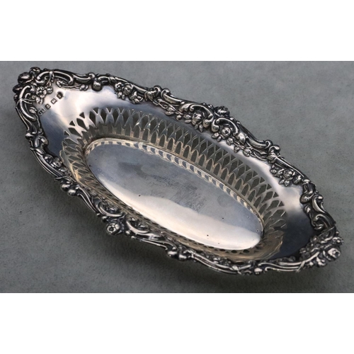 457 - A Birmingham silver oval boat shaped dish with pierced and embossed floral, leaf and scroll rim, 17.... 