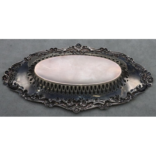 457 - A Birmingham silver oval boat shaped dish with pierced and embossed floral, leaf and scroll rim, 17.... 