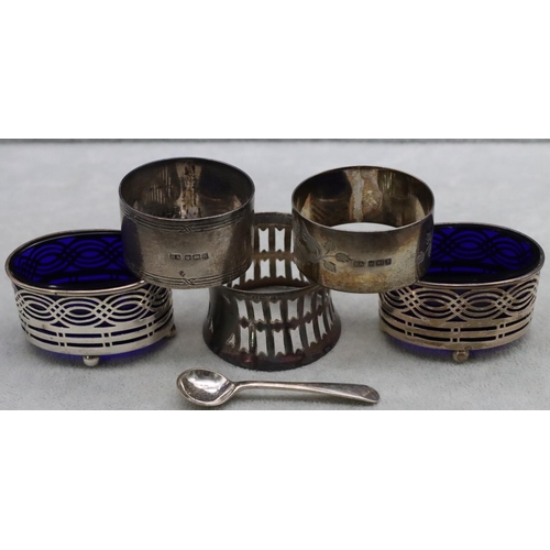 459 - A pair of Birmingham oval silver salts with blue glass liners and ball feet and 3 odd silver napkin ... 