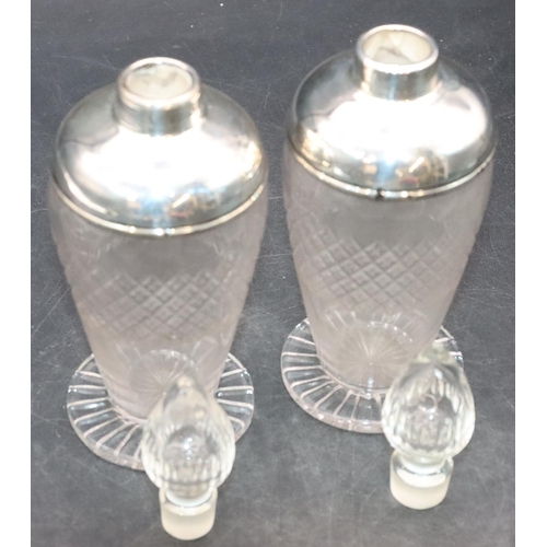 461 - A pair of cut glass round bulbous shaped scent bottles with stoppers and silver shoulders and necks ... 