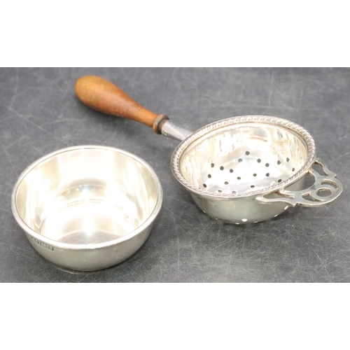 466 - A modern London silver tea strainer with turned wooden handle and similar stand, overall weight 1.7o... 