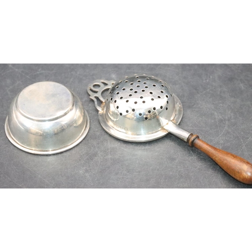 466 - A modern London silver tea strainer with turned wooden handle and similar stand, overall weight 1.7o... 