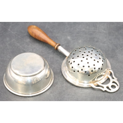 466 - A modern London silver tea strainer with turned wooden handle and similar stand, overall weight 1.7o... 