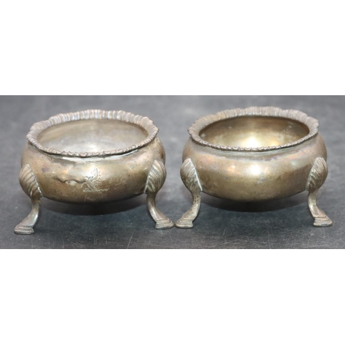 468 - A pair of Victorian silver round bulbous shaped salts with scallop shaped rims on 3 hoof feet, 3.9oz... 