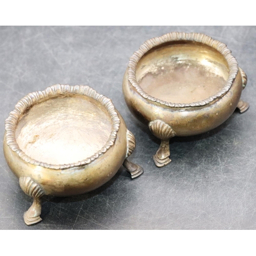 468 - A pair of Victorian silver round bulbous shaped salts with scallop shaped rims on 3 hoof feet, 3.9oz... 