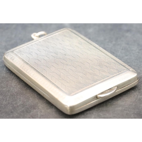 470 - A Chester silver matchbox case holder with allover engine turned decoration and hinged front, 1.1oz