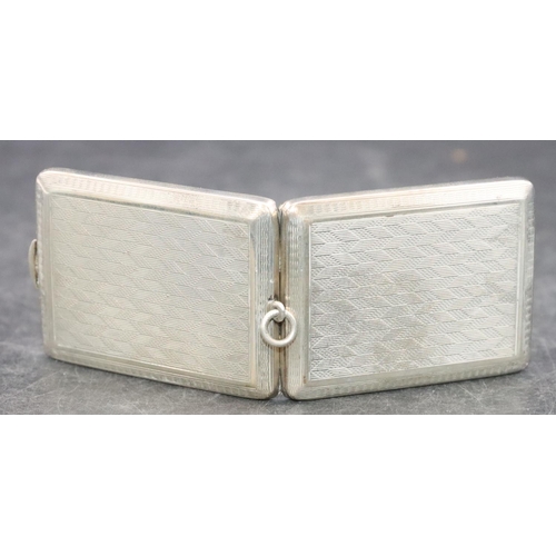 470 - A Chester silver matchbox case holder with allover engine turned decoration and hinged front, 1.1oz