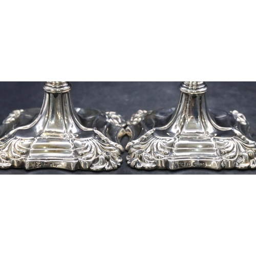 481 - A pair of Victorian Sheffield silver candlesticks on turned stems with square scallop shaped bases a... 