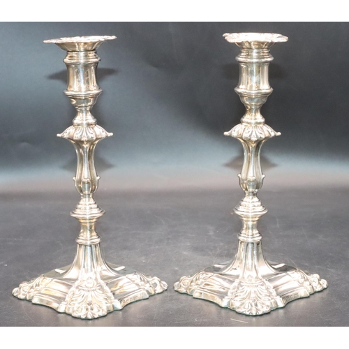 481 - A pair of Victorian Sheffield silver candlesticks on turned stems with square scallop shaped bases a... 