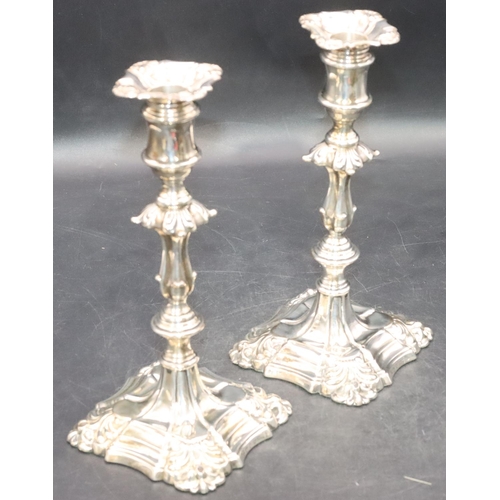 481 - A pair of Victorian Sheffield silver candlesticks on turned stems with square scallop shaped bases a... 