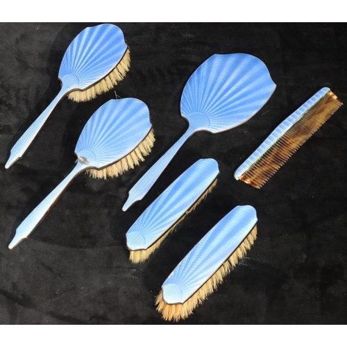 487 - A 6-piece blue enamelled dressing table set, comprising of hand mirror, 4 brushes and comb, in fitte... 