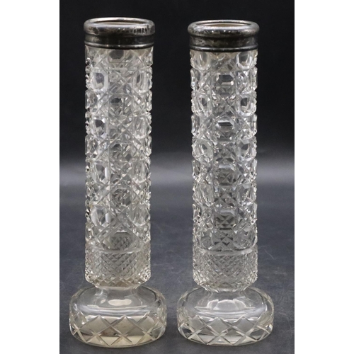 489 - A pair of cut glass cylindrical spill vases with Birmingham silver rims, 20cm high