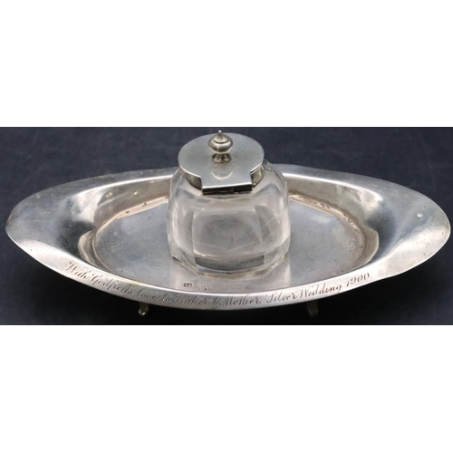 497 - A Birmingham silver oval boat shaped ink stand set with centre cut glass inkwell with silver hinged ... 