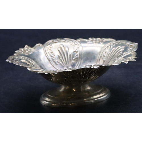 498 - A London silver oval scallop shaped sweet meat dish with allover embossed floral, leaf and scroll de... 