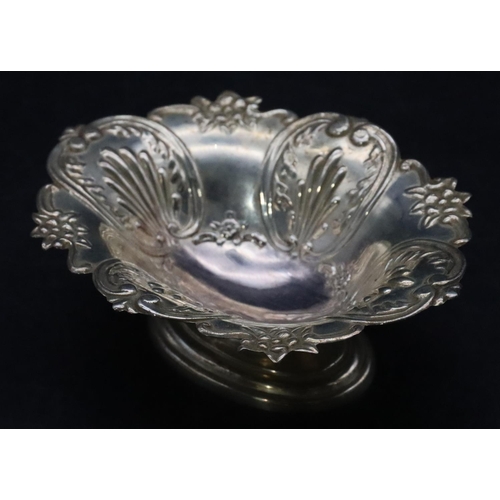 498 - A London silver oval scallop shaped sweet meat dish with allover embossed floral, leaf and scroll de... 