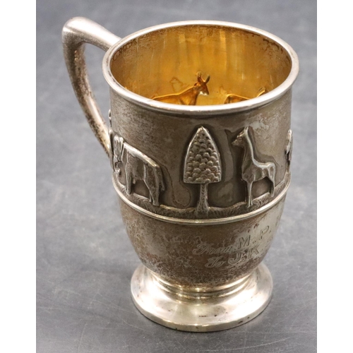 499 - A George VI silver child's christening mug with raised procession of 2 figures, elephant, giraffe, l... 