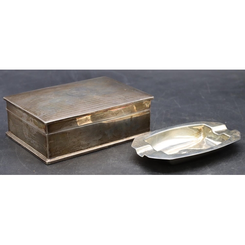 511 - A silver rectangular shaped cigarette box with engine turned hinged lid enclosing cedar lined interi... 