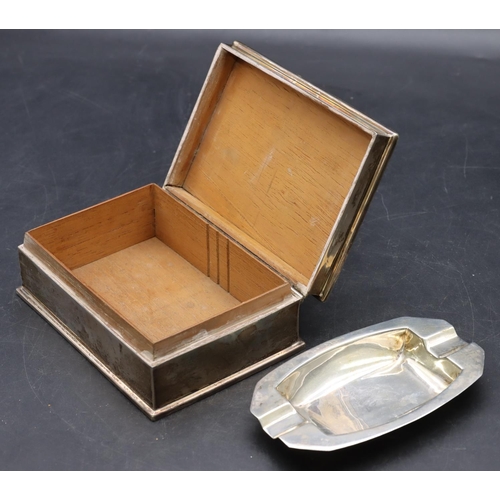 511 - A silver rectangular shaped cigarette box with engine turned hinged lid enclosing cedar lined interi... 