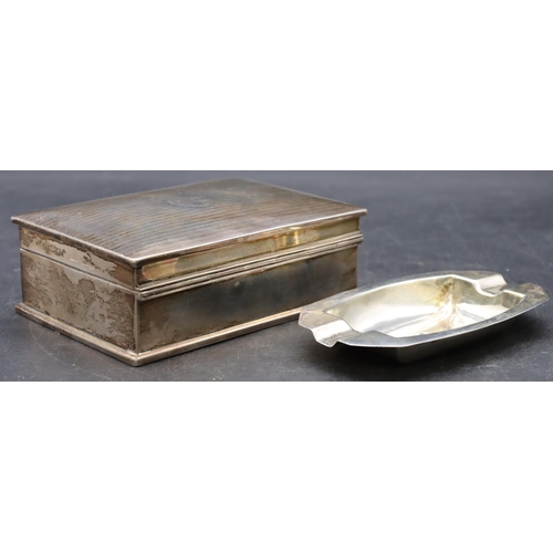 511 - A silver rectangular shaped cigarette box with engine turned hinged lid enclosing cedar lined interi... 