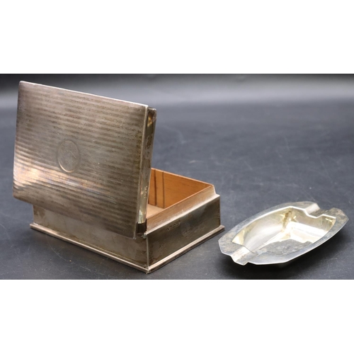 511 - A silver rectangular shaped cigarette box with engine turned hinged lid enclosing cedar lined interi... 