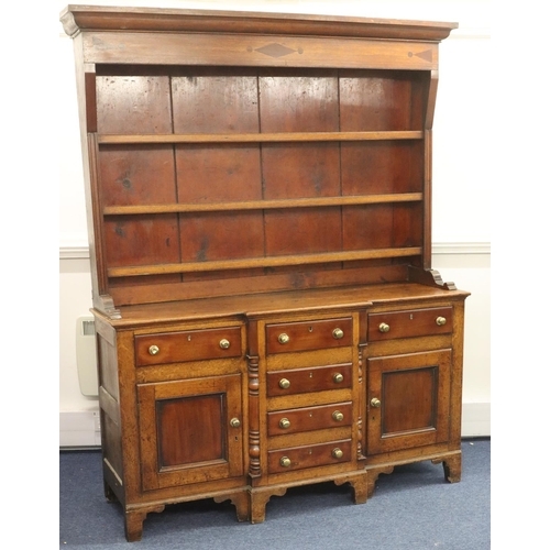 954 - A George III oak and mahogany breakfront Welsh dresser with shelfed back, 4 graduated centre drawers... 