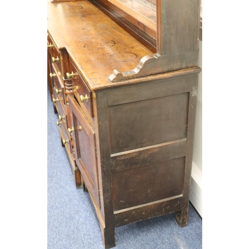 954 - A George III oak and mahogany breakfront Welsh dresser with shelfed back, 4 graduated centre drawers... 