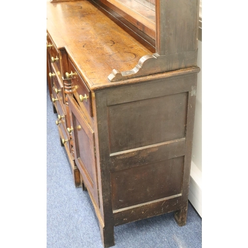 954 - A George III oak and mahogany breakfront Welsh dresser with shelfed back, 4 graduated centre drawers... 