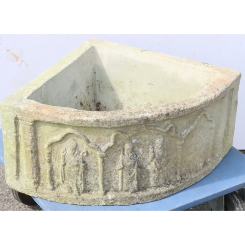 881 - A garden corner half round jardinière with raised figure decoration, 66cm wide, 50.5cm deep and 26cm... 