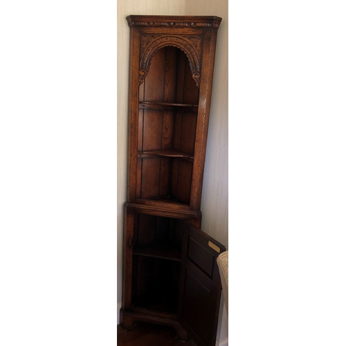 9016 - Titchmarsh and Goodwin oak corner cabinet, 2 upper shelves, lower carved panel door enclosing interi... 