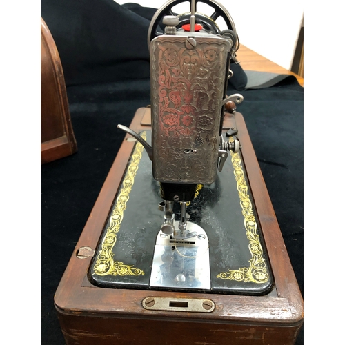 9024 - A vintage Singer sewing machine with original wood carrying case, model number F7666313, with lock a... 