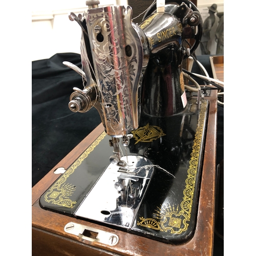 9050 - An electric Singer sewing machine No. K5935823, Serial No. EF099639 with accessories, pedal and cabl... 