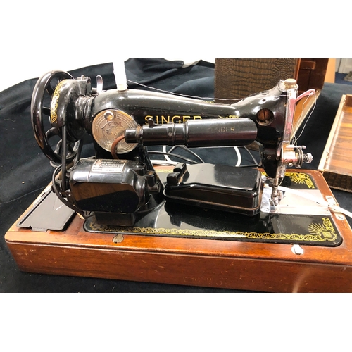 9050 - An electric Singer sewing machine No. K5935823, Serial No. EF099639 with accessories, pedal and cabl... 