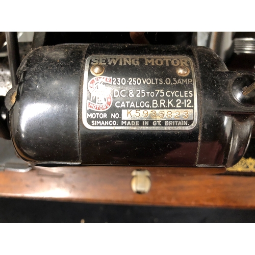 9050 - An electric Singer sewing machine No. K5935823, Serial No. EF099639 with accessories, pedal and cabl... 