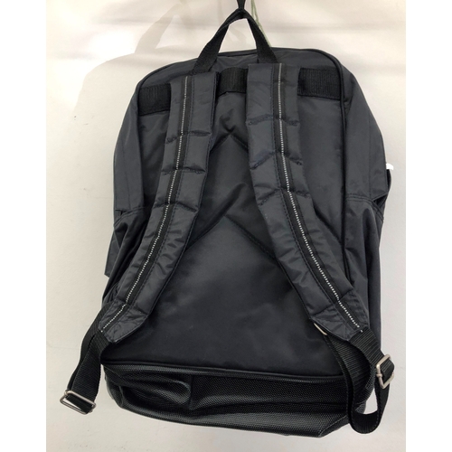 9054 - A black canvas rucksack with Dr. Martens logo. (As new)