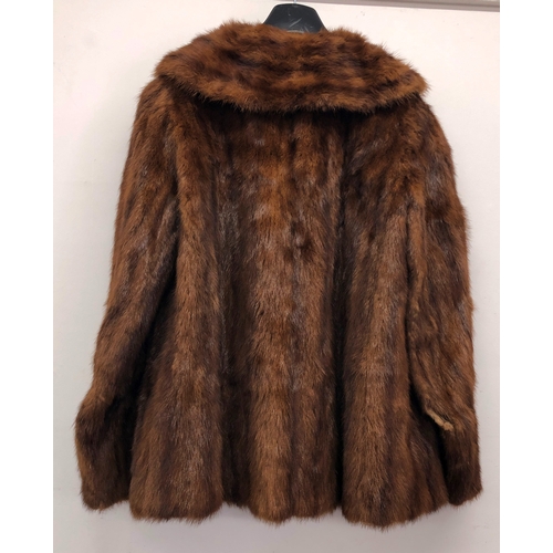 9060 - A brown short mink fur jacket, labelled Theodore Roach, 67cm long, sleeve 62cm long (hole in 1 sleev... 