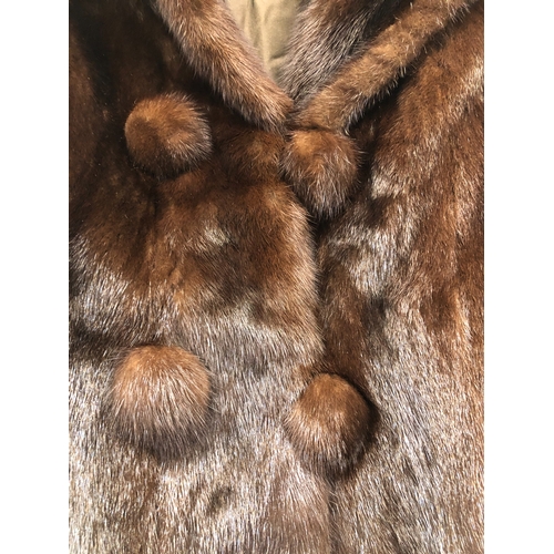 9061 - A short brown mink fully lined  fur coat with 4 buttons, 64cm long, sleeves 59cm long, size 10/12