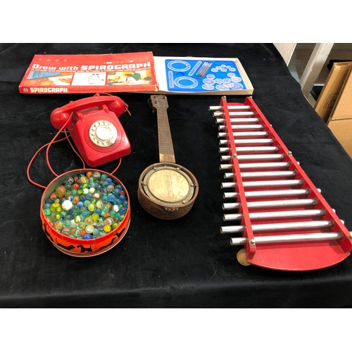 9072 - A xylophone, a miniature banjo (a/f), a red Bakelite telephone, a quantity of marbles and a child's ... 