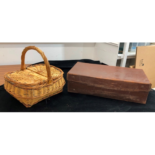 9076 - A Brown leather suitcase, 66cm wide, 38cm deep, 18 cm high and a wicker picnic basket. (2)