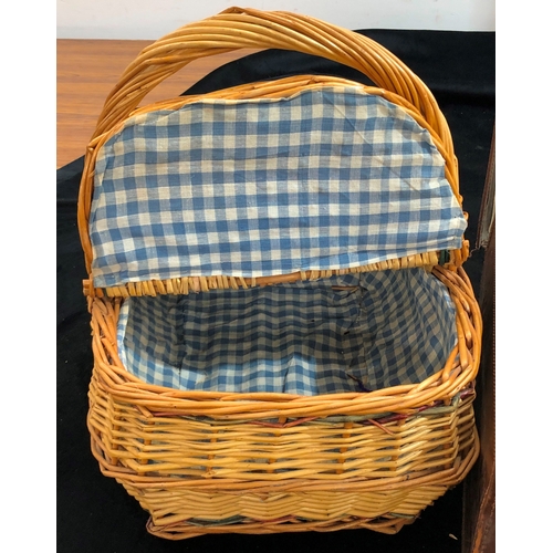 9076 - A Brown leather suitcase, 66cm wide, 38cm deep, 18 cm high and a wicker picnic basket. (2)