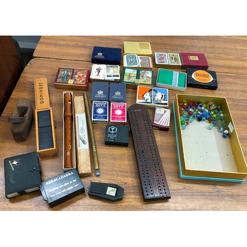 9104 - A quantity of playing cards including Waddington's (some unopened), a cribbage board, an Adler recor... 