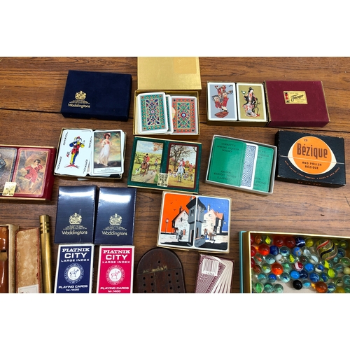 9104 - A quantity of playing cards including Waddington's (some unopened), a cribbage board, an Adler recor... 