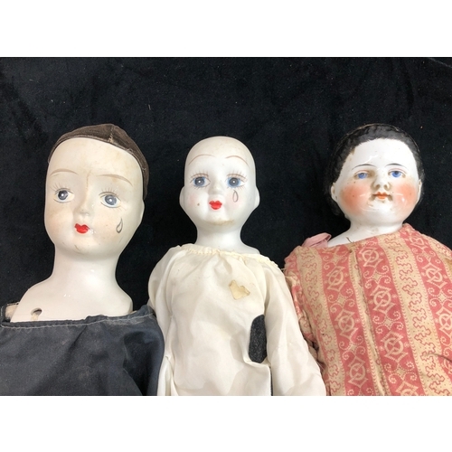 9065 - A china headed doll, 49cm long and 2 other dolls.