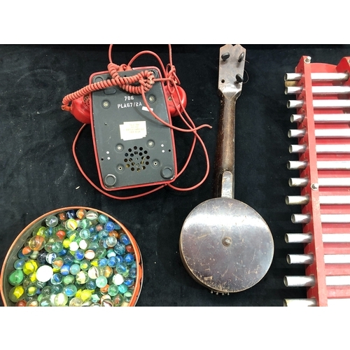 9072 - A xylophone, a miniature banjo (a/f), a red Bakelite telephone, a quantity of marbles and a child's ... 