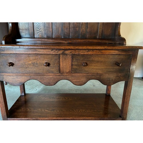 9223 - An oak dresser (in 2 pieces), 2 shelves above the main dresser with 4 peg hooks to sides, plate hold... 