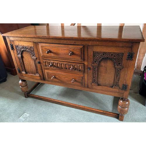 9231 - A1920's oak sideboard with 2 hinged doors with wooden knob handles, sitting either side of 3 central... 