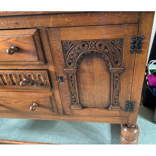 9231 - A1920's oak sideboard with 2 hinged doors with wooden knob handles, sitting either side of 3 central... 